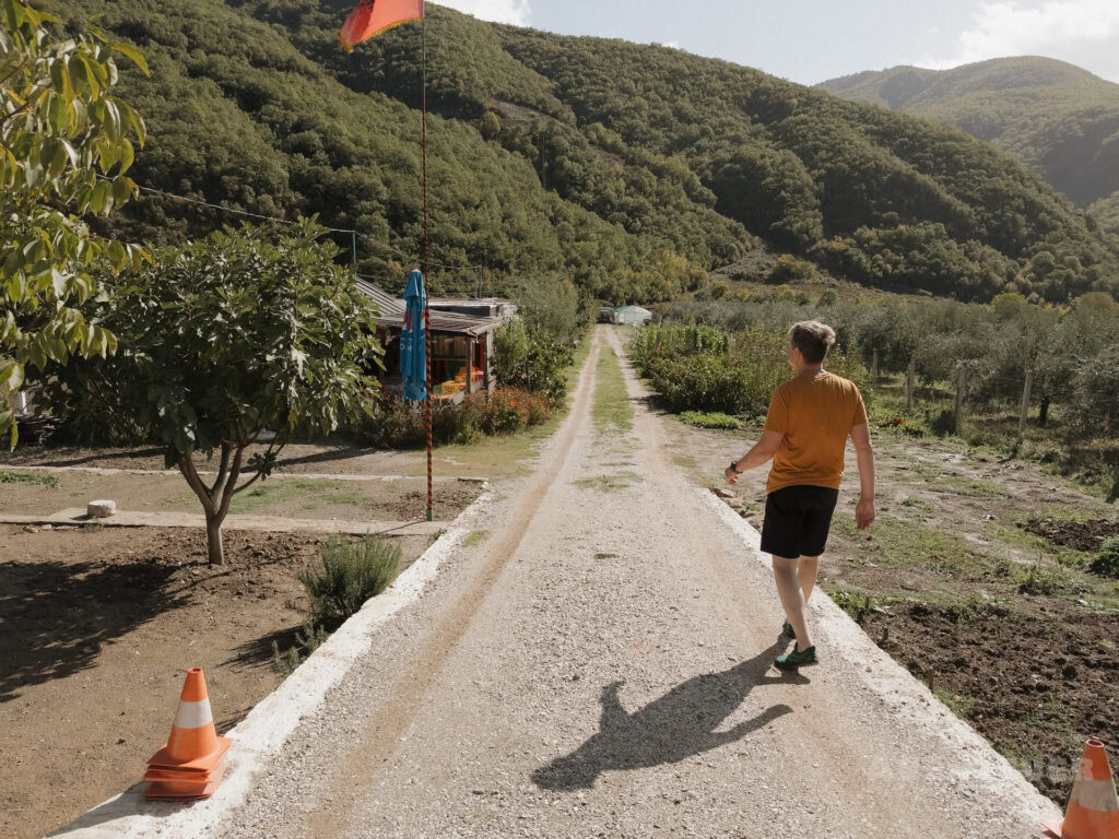 Junge Person wandert auf einem Weg durch die Natur bei heißen Quellen in den Bergen.