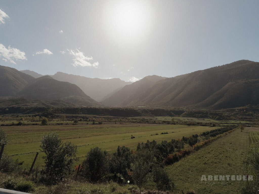 Heiße Quellen in den Bergen bei Tag, umgeben von grünen Tälern und majestätischen Gipfeln. Perfekt f.